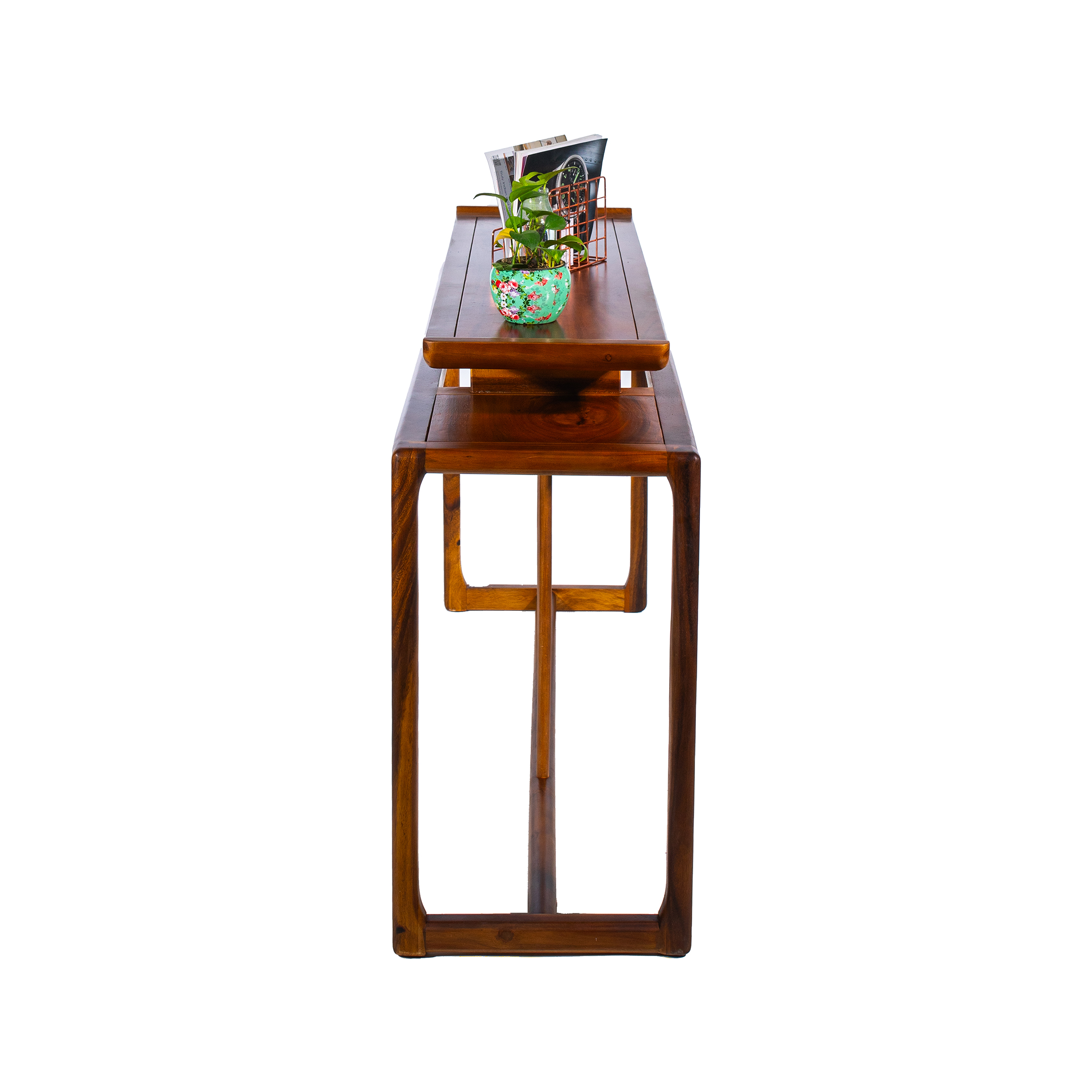 Elegant wooden table with vertical slats, featuring a book and two small potted plants on top, against a simple white background.