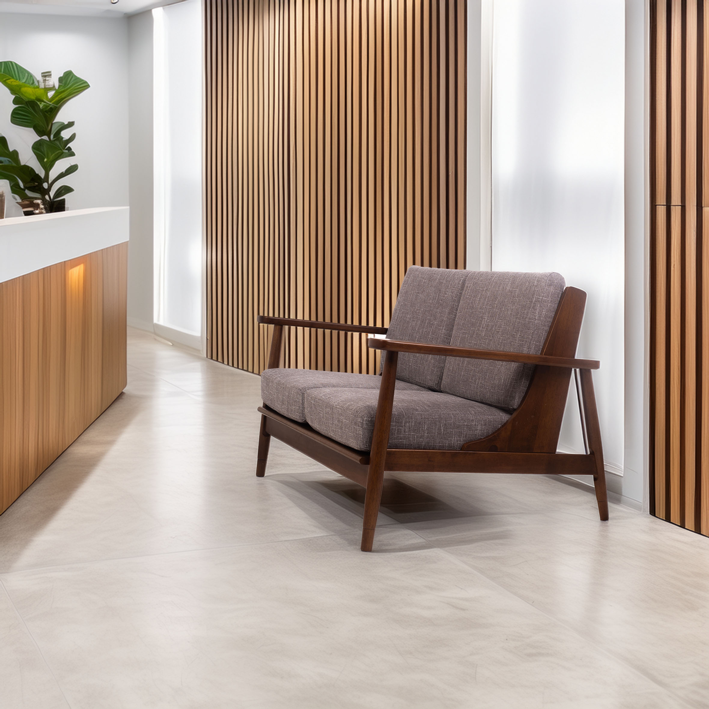 Mid-century modern furniture in a minimalist office. A wooden sofa with gray cushions sits on a beige tiled floor near a white desk and wood panel walls.